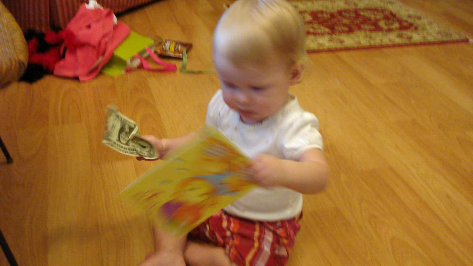 Emily with a birthday card and a dollar bill