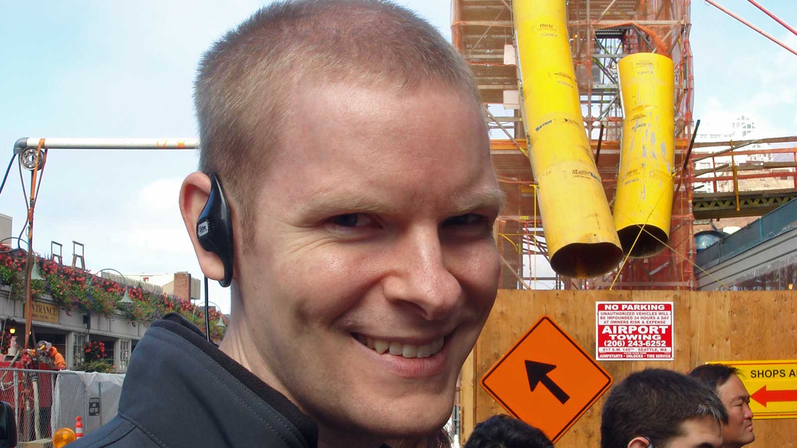 William with a wireless earpiece in his ear
