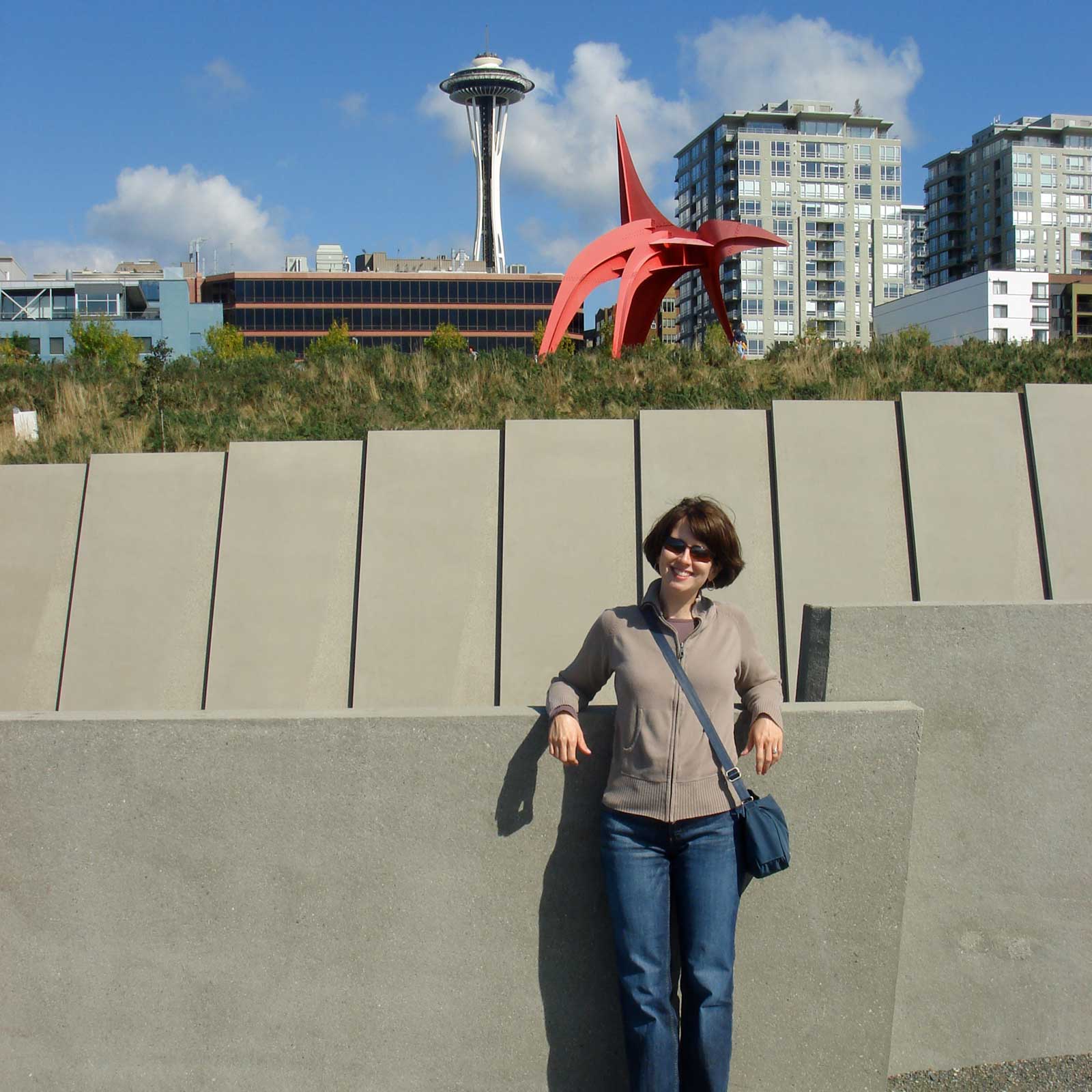 Rebecca with a large red modern art sculpture and the Space Needle in the
background